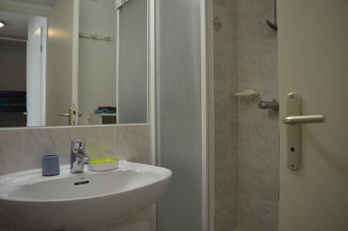 une salle de bain avec un lavabo, un miroir et une douche dans l'établissement Appartement 2 pièces cabine 6 couchages SAINT CYPRIEN SC050-288A, à Saint Cyprien Plage
