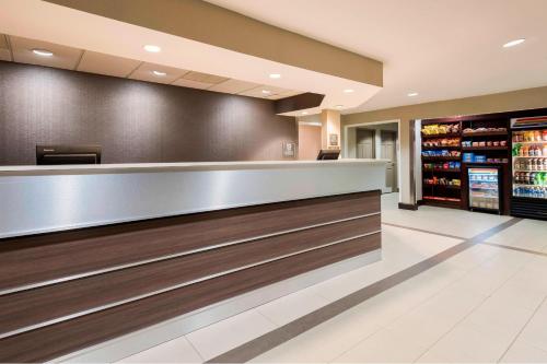 a bar in a hotel lobby with a drink counter at Residence Inn Tallahassee North I-10 Capital Circle in Tallahassee