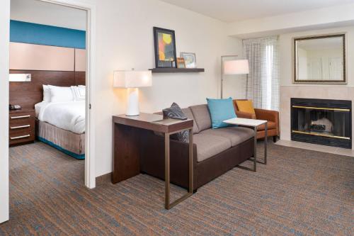 a hotel room with a couch and a bed at Residence Inn by Marriott Branson in Branson