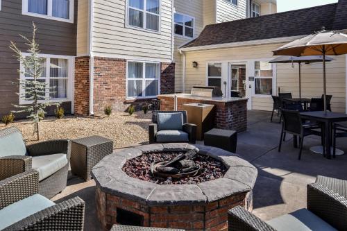 a patio with a fire pit with chairs and tables at Residence Inn by Marriott Branson in Branson