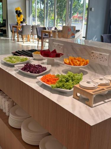 a buffet with different types of vegetables on a counter at Lavigo Resort in Pantai Cenang