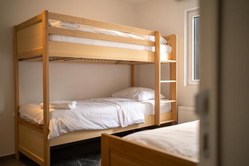 two bunk beds in a room with a window at The Edgewater Suites - Cityscape in Namur