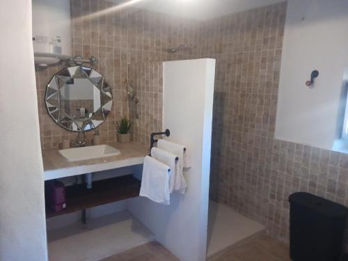 a bathroom with a sink and a mirror at Casa rural los Cerezos in Albox