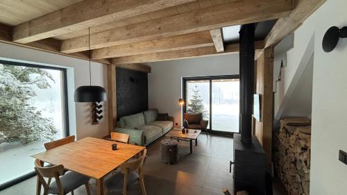 a living room with a table and a couch at 2domky in Horní Černá Studnice
