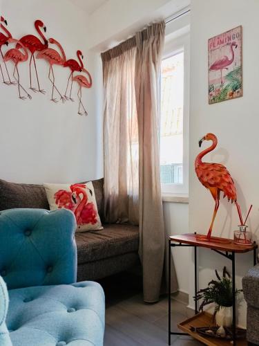 a living room with red flamingos on a couch at Flamingo in Sesimbra