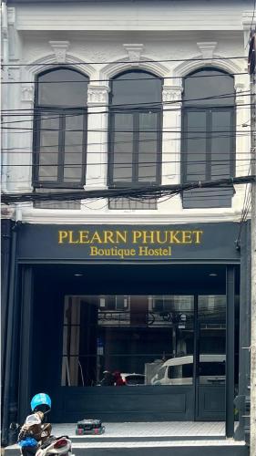 a building with a sign for a furniture store at Plearn Phuket Boutique Hostel in Ban Lo Long