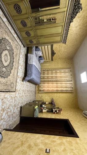 a living room with a couch and a ceiling at Rustic Mountain Oasis in Sayḩ aş Şaqlah