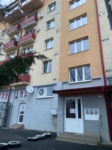 an apartment building with a door and some shoes on the street at 7 people - 1 price - Cozy attic apartment in Prešov