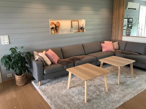a living room with a couch and two tables at Beautiful residence, close to great beaches good for surfing in Klepp