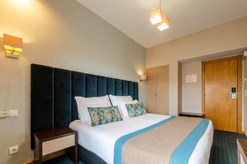 Letto o letti in una camera di Hotel DAH - Dom Afonso Henriques