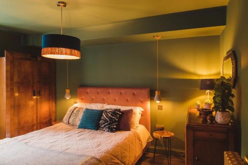 a bedroom with a large bed with a blue wall at Ballarat House in Margate
