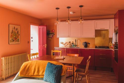 a kitchen and dining room with a table and chairs at Ballarat House in Margate