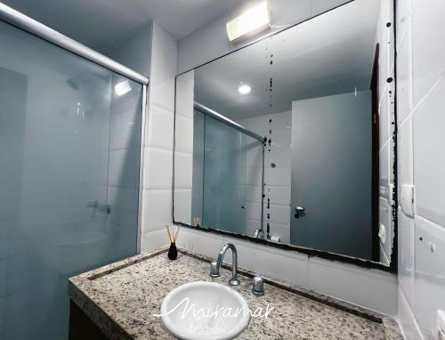 a bathroom with a sink and a large mirror at Imperial Nobile in Tambaú