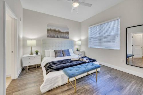 a bedroom with a large bed and a mirror at Trendy One Bedroom Getaway Steps from Biscayne in Miami