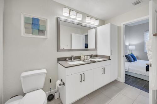 a bathroom with a toilet and a sink and a mirror at Trendy One Bedroom Getaway Steps from Biscayne in Miami