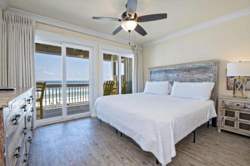 une chambre avec un lit blanc et un balcon dans l'établissement BeachFront 5Bed EasyBreezy East, à Gulf Shores