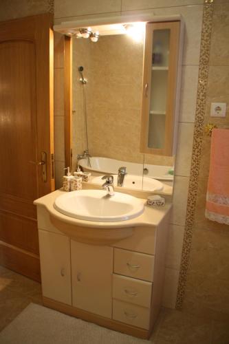 a bathroom with a sink and a mirror and a tub at Castelo dos Sonhos in Valadares