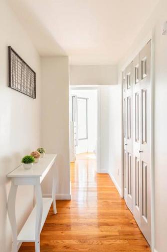 a room with a white table and a hallway at Charming Duplex4min To Mohegan18min To Foxwoods in Norwich