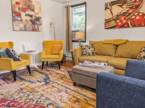 a living room with yellow chairs and a couch at Charming Duplex4min To Mohegan18min To Foxwoods in Norwich