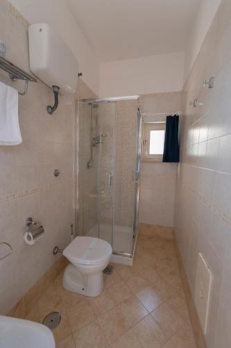 a bathroom with a shower and a toilet and a sink at Artis Mare in Pozzuoli