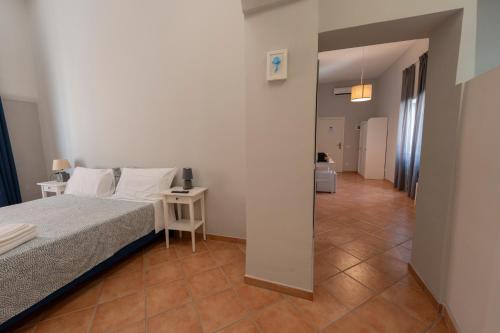 a bedroom with a bed and a hallway at Artis Mare in Pozzuoli