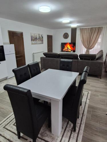 a living room with a table and chairs and a couch at Bjance Lux Prijepolje in Prijepolje