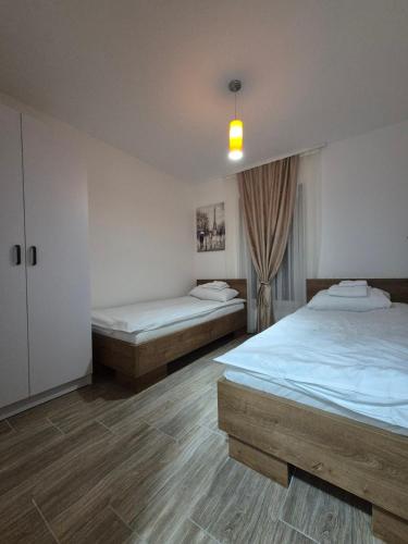 a bedroom with two beds and a window at Bjance Lux Prijepolje in Prijepolje