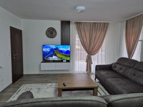 a living room with a couch and a flat screen tv at Bjance Lux Prijepolje in Prijepolje