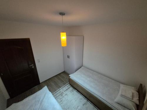 a small room with two beds and a light at Bjance Lux Prijepolje in Prijepolje