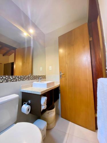 a bathroom with a toilet and a sink and a mirror at Mandala Apartments 2 ambientes in Luque
