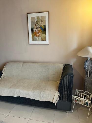 a bed in a room with a picture on the wall at Mandala Apartments 2 ambientes in Luque