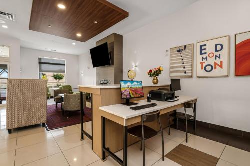 an office with a desk and a computer in a room at Holiday Inn Express Hotel & Suites-Edmonton South by IHG in Edmonton
