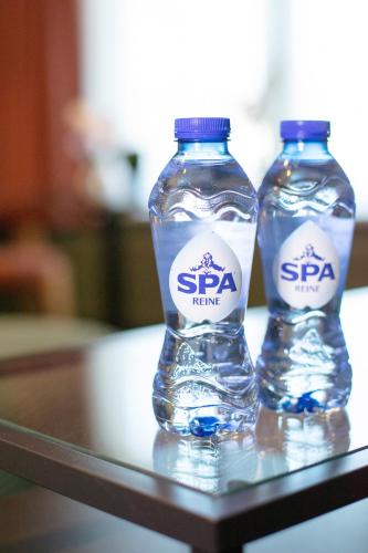 two bottles of water sitting on top of a table at Gillis Eight Guest Rooms by Romy&Travis in Bruges