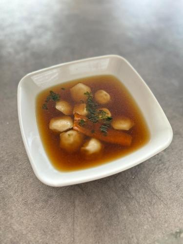 a bowl of soup with potatoes and carrots in it at Domek 4-6osobowy in Wroceń