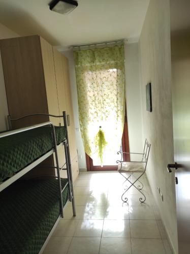 a room with a bunk bed and a window at Casa Marina in Sestu