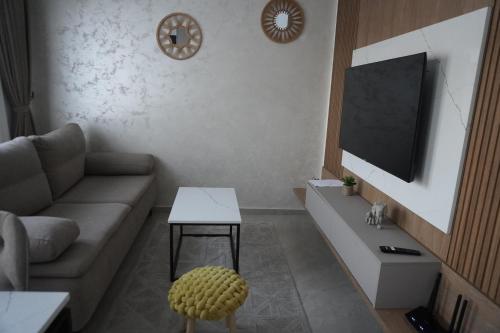 a living room with a couch and a flat screen tv at Vienna Luxury Apartments in Dobra Voda