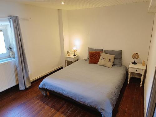 a bedroom with a bed with two night stands at La ferme - Domaine Monbel in Mirepoix