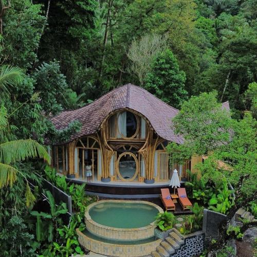 a house with a pool in the middle of a forest at Punduk Villa - The Manta in Selat