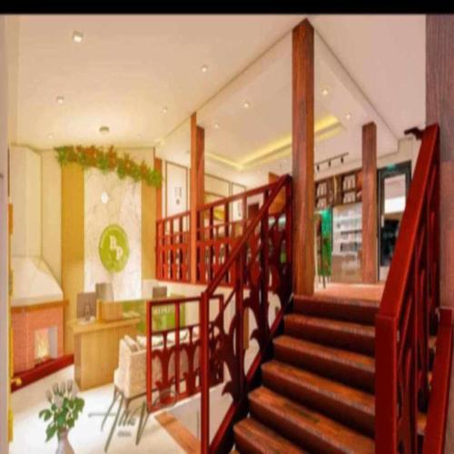 a lobby with a staircase in a house at Baden Powell Hostel in Baguio