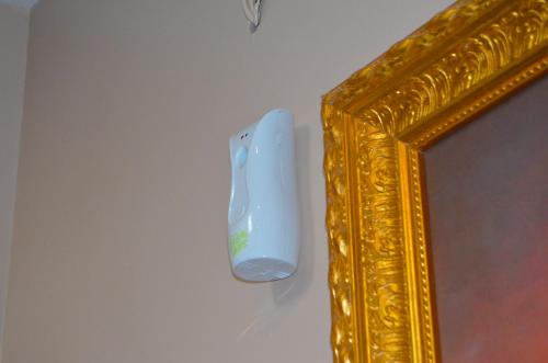 a nintendo wii game controller hanging from a mirror at Residency Apartment and Hotel Guzape Hills Abuja in Abuja