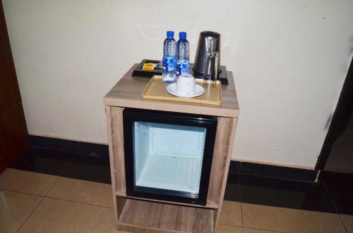 a small table with blue bottles on top of it at Residency Apartment and Hotel Guzape Hills Abuja in Abuja