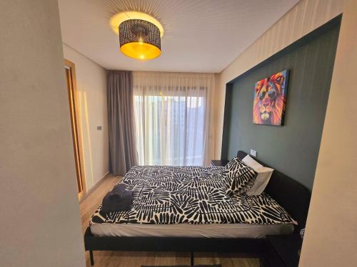 a bedroom with a zebra print bed with a window at Luxe & Confort in Cité de Bournazel