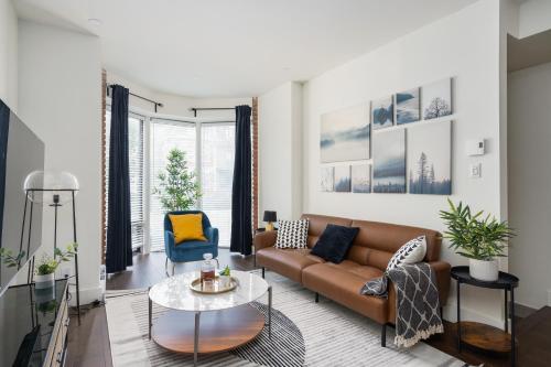 a living room with a couch and a table at Les Lofts du Mile End-Plateau Mont Royal in Montréal