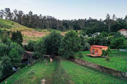 a small house on a hill with a field at Peneda-Gerês - Nature Pool - Garden - Parking free in Sabadim
