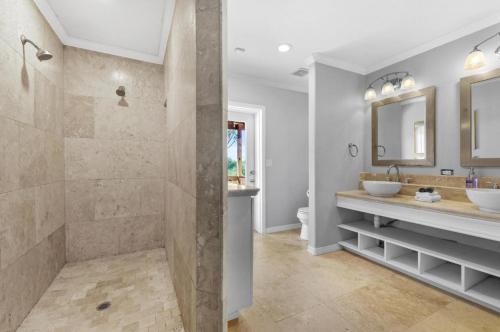 a bathroom with two sinks and a shower at #1 Largest Tampa Private Compound 13BR Sleeps 40 Heated Pool Spa in Tampa