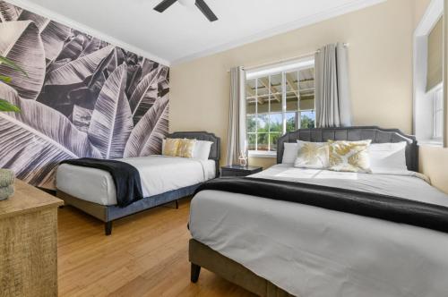 a bedroom with two beds and a large window at #1 Largest Tampa Private Compound 13BR Sleeps 40 Heated Pool Spa in Tampa