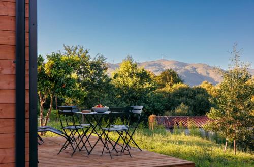a table with a bowl of fruit on it on a deck at Peneda-Gerês - Nature Pool - Garden - Parking free in Sabadim