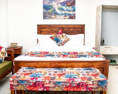 a bedroom with a bed with a quilt on it at Koselig Studio Apartment with Swimming Pool in Naro Moru