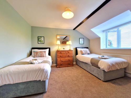 En eller flere senge i et værelse på Town Farm Cottage