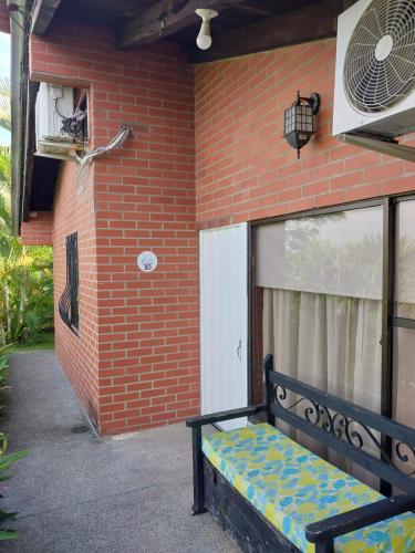 a bench sitting in front of a brick building at Hotel San Antonio del Cerro in Pereira
